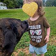 Gabby is registered to the contest to win money with this photo: dog, toddler, child, grass, outdoor, shirt, sneakers, tree, sky, greenery, pet, playing, cute, young_child, casual_clothing, animal, nature, daytime, funny_shirt, interaction