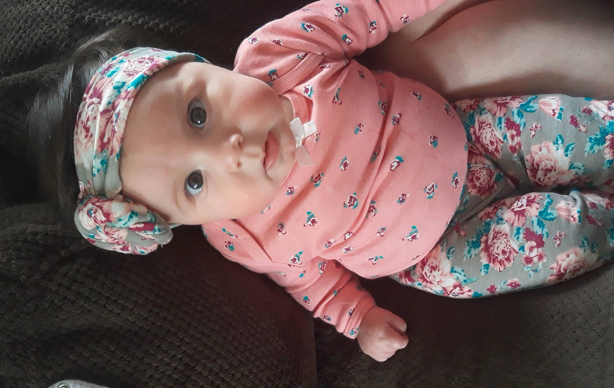 Raelynn is registered to the contest to win money with this photo: arm, baby, baby_toddler_clothing, cheek, child, eye, facial_expression, finger, happy, head, headgear, headwear, human_body, lip, mouth, nose, pattern, person, pink, skin