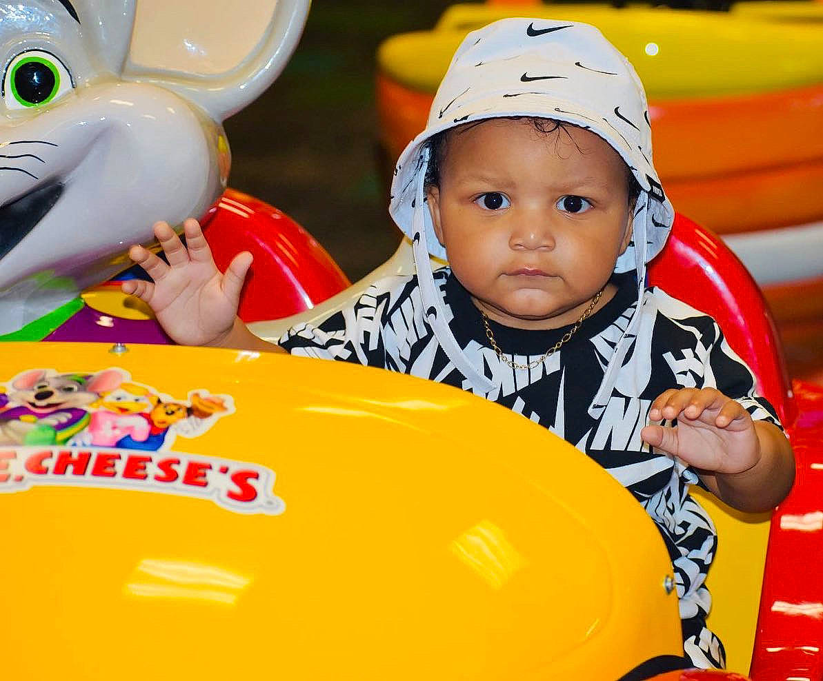 Nash is registered to the contest to win money with this photo: baby, baby_products, baby_toddler_clothing, cap, child, facial_expression, fun, happy, headwear, leisure, mammal, orange, organ, person, personal_protective_equipment, play, product, recreation, snapshot, toddler