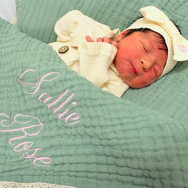 Sallie joined the competition — help win amazing prizes! baby, bed, bedroom, blanket, bonnet, clothing, crib, face, furniture, hat, head, indoors, infantbed, newborn, person, photography, portrait, quilt, room, sleeping