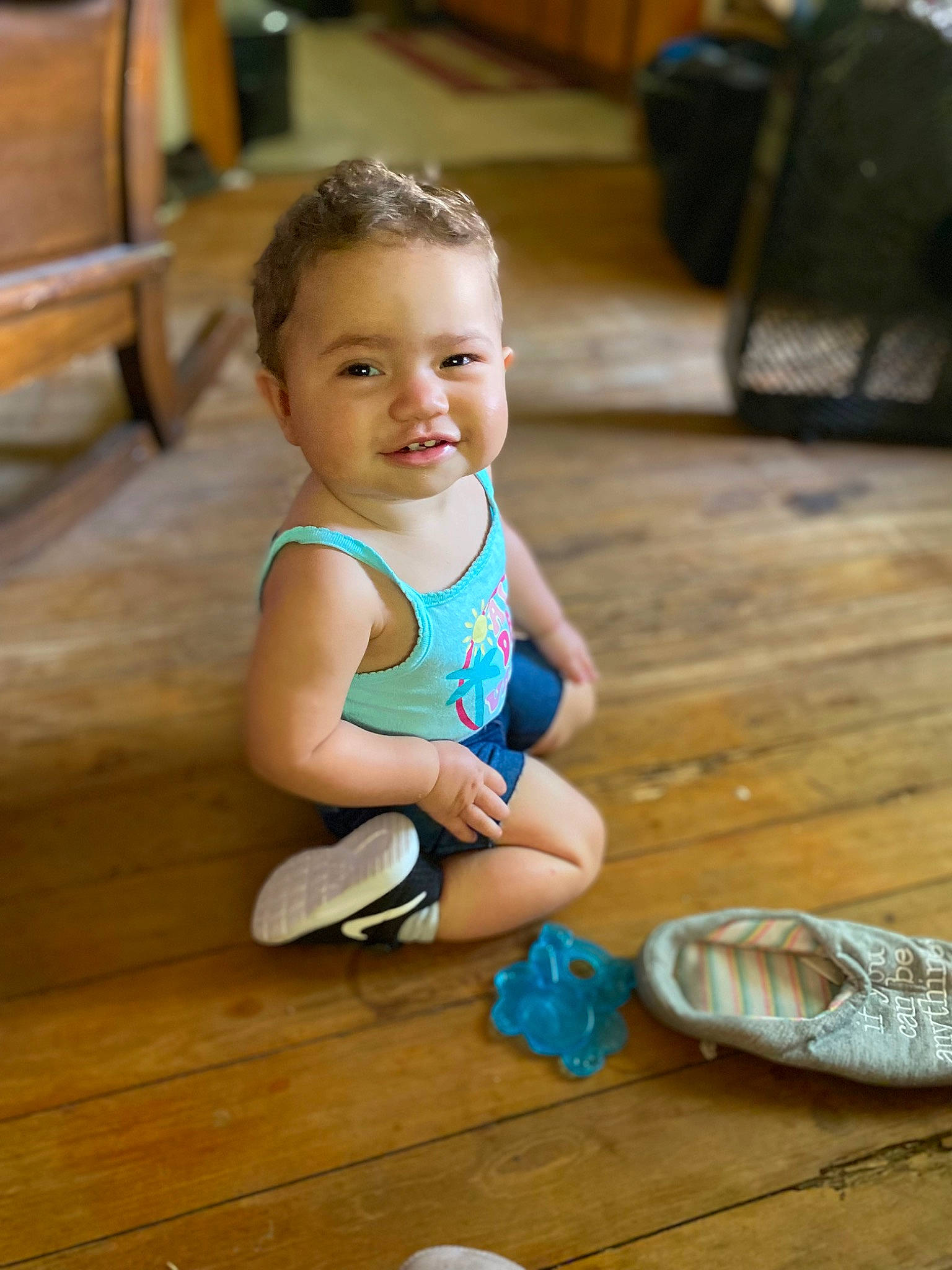 Mariah is registered to the contest to win money with this photo: baby, baby_toddler_clothing, child, floor, flooring, foot, fun, happy, hardwood, human_leg, leisure, person, shorts, sitting, skin, smile, standing, thigh, toddler, wood