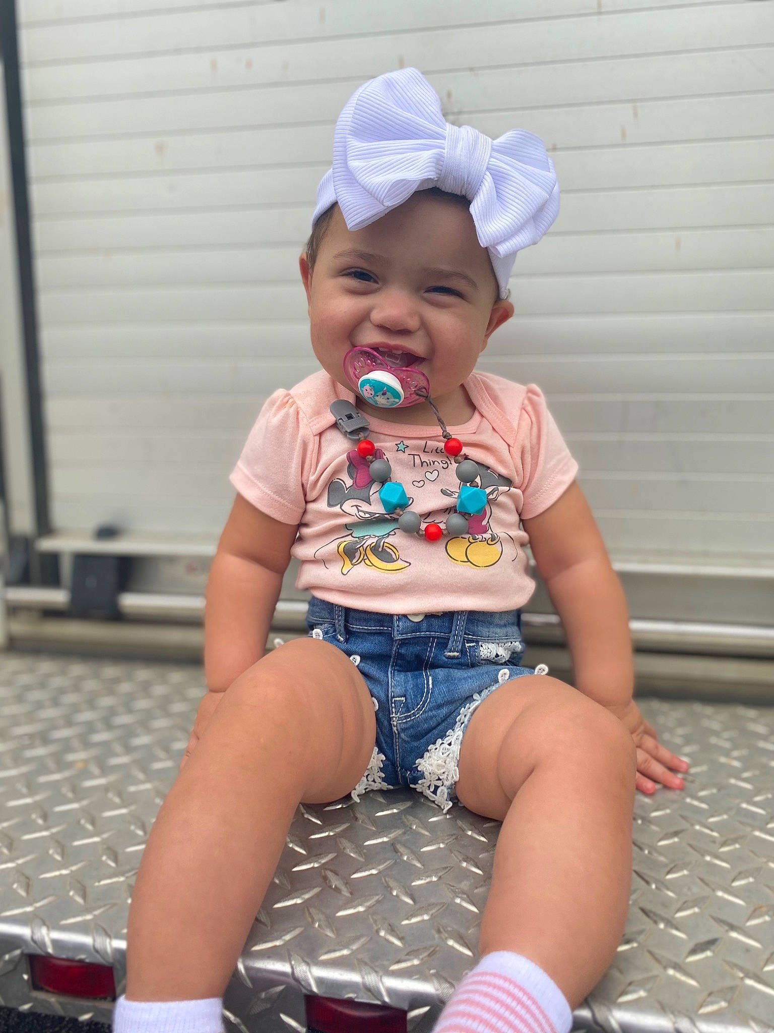 Mariah is registered to the contest to win money with this photo: baby, baby_toddler_clothing, baseball_cap, cap, cool, foot, fun, happy, headwear, human_leg, knee, lap, leisure, person, pink, sleeve, smile, standing, t_shirt, thigh