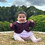 baby, child, smiling, outdoor, grass, purple_cardigan, white_outfit, hair_clip, happy, sitting, nature, greenery, cloudy_sky, cute, portrait, young_child, person, clothing, feet, face