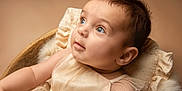 Elizabeth joined the competition — help win amazing prizes! baby, infant, child, portrait, face, blue_eyes, soft_lighting, cream_dress, ruffled_cushion, close_up, cute, adorable, skin, expression, looking_up, newborn, soft_texture, warm_colors, toddler, indoors
