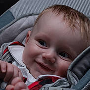 Kieran John joined the competition — help win amazing prizes! baby, child, closeup, clothing, cozy, cushion, cute, eyes, face, grey, hand, happy, head, infant, portrait, red, seat, skin, smiling, young