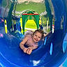 Scarlett is registered to the contest to win money with this photo: amusementpark, baby, face, grass, head, indoors, nature, outdoorplayarea, outdoors, park, person, photography, plant, playarea, portrait, slide, summer, toy, water, waterpark