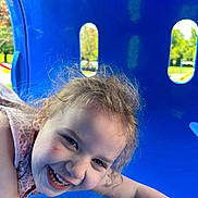 Scarlett is registered to the contest to win money with this photo: amusementpark, baby, bodypart, face, grass, happy, head, laughing, mouth, outdoorplayarea, outdoors, person, photography, playarea, portrait, slide, smile, summer, teeth, toy