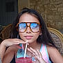 May Lynn participe au concours pour gagner de l'argent avec cette photo : beverage, cafe, casual_clothing, child, colorful, drink, girl, glass, glasses, indoor, long_hair, portrait, refreshment, relaxed, stone_wall, straw, summer, table, wicker_chair, young