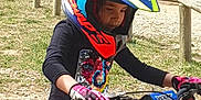 May Lynn participe au concours pour gagner de l'argent avec cette photo : child, helmet, motorcycle, gloves, outdoor, dirt_bike, motorbike, person, vehicle, grass, car, protective_gear, helmet_visor, riding, motor_sport, seated, daylight, safety, youth, park