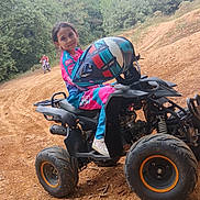 May Lynn participe au concours pour gagner de l'argent avec cette photo : activity, adventure, casual, child, dirt, dirt_track, forest, fun, helmet, helmet_held, motorbike, nature, outdoor, person, quad_bike, riding_gear, sport, trees, vehicle, young