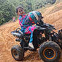 activity, adventure, casual, child, dirt, dirt_track, forest, fun, helmet, helmet_held, motorbike, nature, outdoor, person, quad_bike, riding_gear, sport, trees, vehicle, young