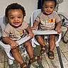 Kevin And Keldrick joined the competition — help win amazing prizes! toddler, child, high_chair, indoor, smiling, matching_clothes, sandals, tshirt, floor_tile, lamp, window, curtain, happy, person, furniture, baby, two_children, cute, home, seated