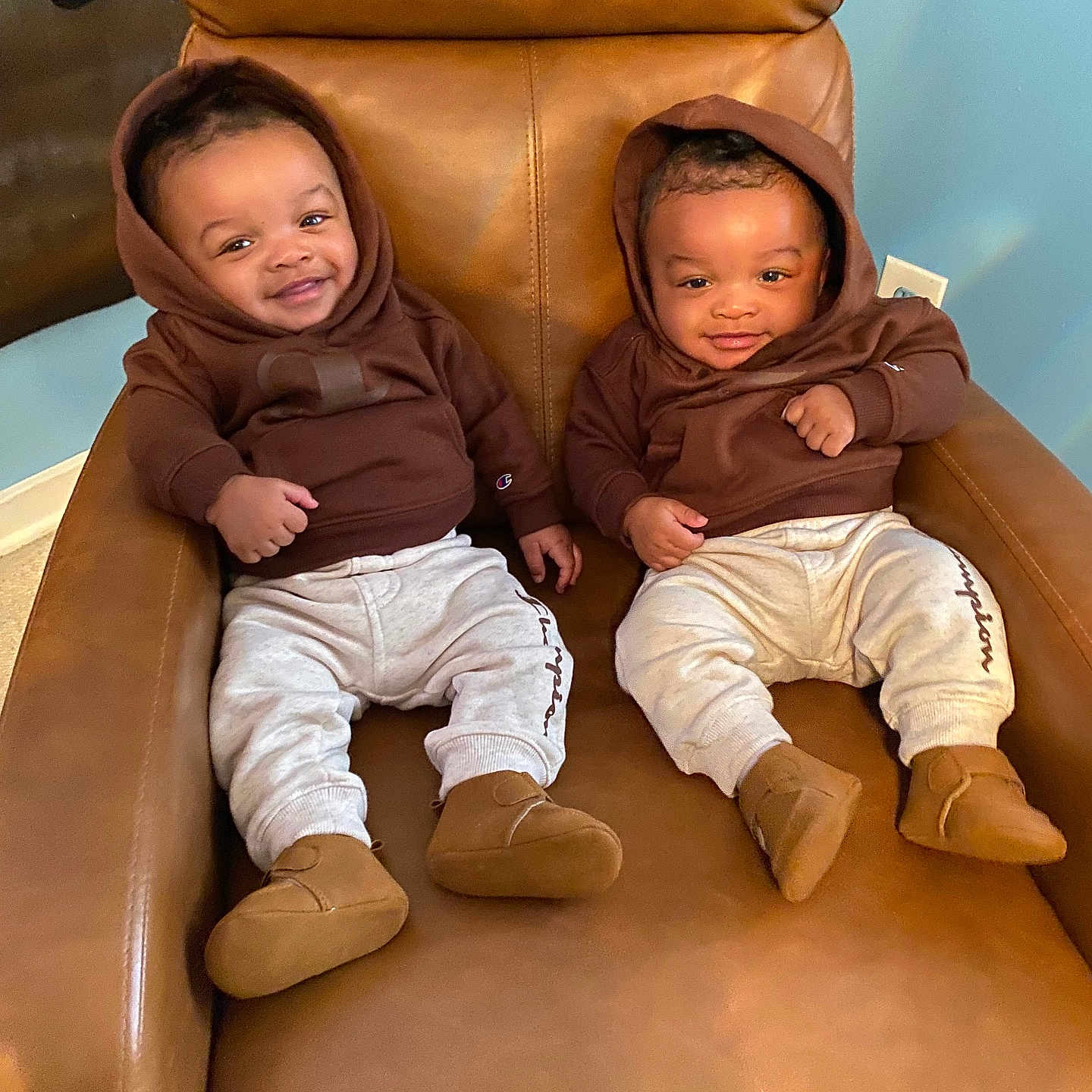 Kevin And Keldrick joined the competition — help win amazing prizes! baby, chair, child, cozy, cute, happy, home, hoodie, indoor, infant, leather, matching_outfits, pants, person, portrait, relaxed, shoes, sitting, smiling, twins