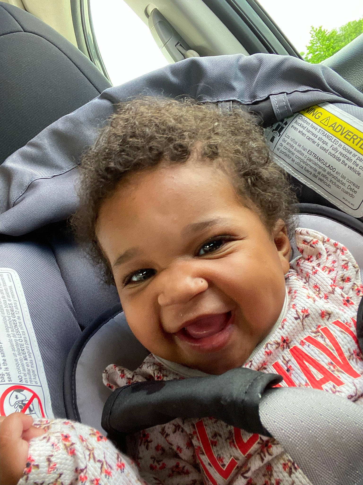Arianna joined the competition — help win amazing prizes! black, car_seat, comfort, eye, face, facial_expression, gesture, happy, human, motor_vehicle, nose, people, person, photograph, plant, product, skin, smile, toddler, tree