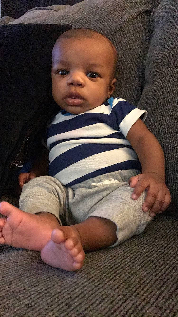 Jamarion is registered to the contest to win money with this photo: baby, cheek, child, finger, leg, person, sitting, skin, toddler