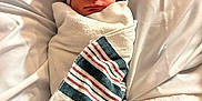 Julian is registered to the contest to win money with this photo: newborn, baby, sleeping, wrapped, blanket, hat, beanie, striped, hospital, bed, white, soft, peaceful, infant, cute, portrait, child, resting, cozy, swaddled