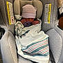 Julian is registered to the contest to win money with this photo: newborn, baby, car_seat, blanket, pacifier, hat, infant, sleeping, child, safety, fabric, cushion, person, indoor, soft, wrapped, seat, striped, resting, cute