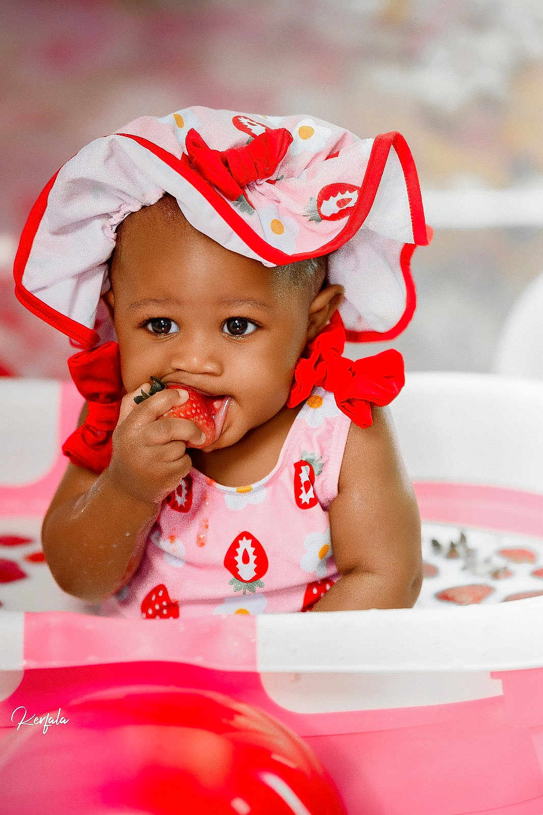 Anaya joined the competition — help win amazing prizes! baby, child, strawberry, milk_bath, pink, red, hat, bonnet, fruit, playful, cute, sitting, milk, water, tub, infant, smiling, food, portrait, fun