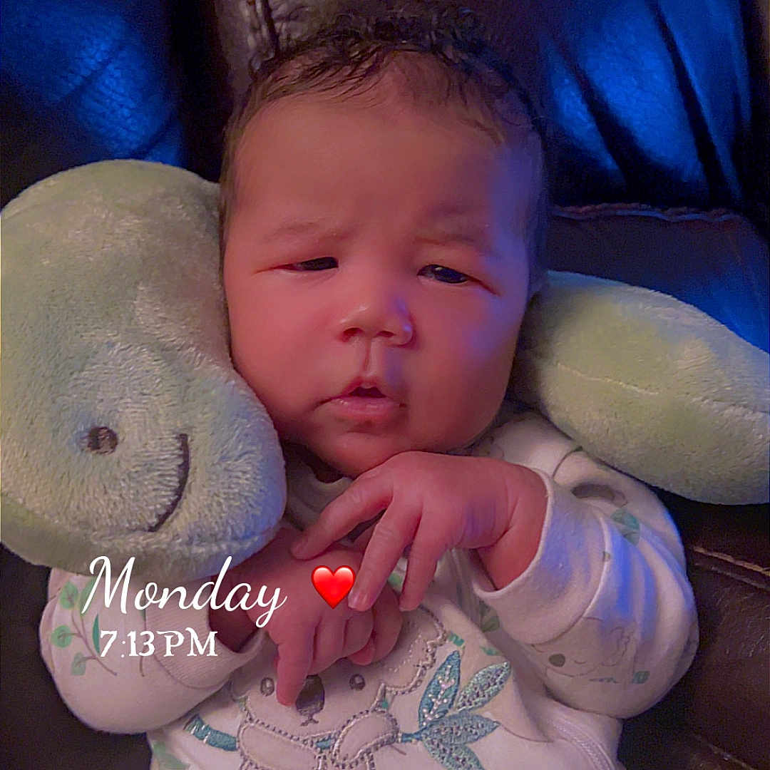 Xavier is registered to the contest to win money with this photo: baby, infant, child, portrait, sleepy, sitting, plush_toy, bunny, stuffed_animal, chair, cushion, onesie, pajamas, clothing, indoors, close_up, face, hands, monday, date_stamp