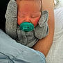 Camille is registered to the contest to win money with this photo: baby, newborn, pacifier, mittens, gray_clothing, blue_blanket, sleeping, infant, closeup, arm, resting, cozy, cute, child, portrait, indoor, soft_light, peaceful, person, human