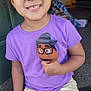 Marley joined the competition — help win amazing prizes! child, smiling, puppet, purple_tshirt, shorts, curly_hair, indoors, doorstep, happy, person, toy, casual_clothing, sitting, young, cute, playful, home, carpet, hand, face