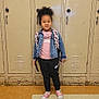 Marley is registered to the contest to win money with this photo: child, locker, backpack, denim_jacket, pink_shirt, nike_sweatpants, pink_shoes, tile_floor, school, indoor, smiling, standing, curly_hair, casual_clothing, person, young_child, portrait, happy, fashion, footwear