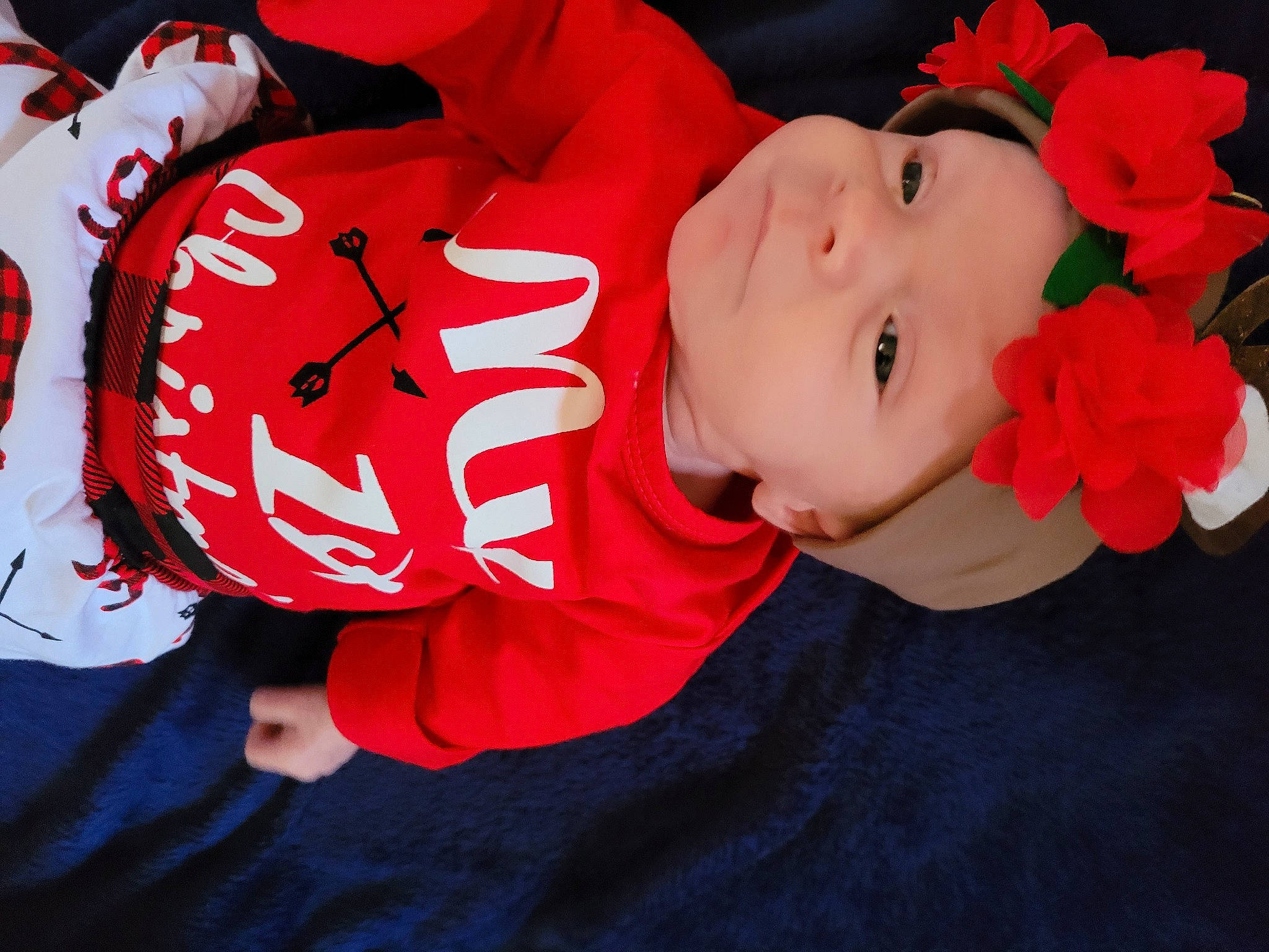 Ayla is registered to the contest to win money with this photo: artificial_flower, baby, baby_toddler_clothing, carmine, cheek, cut_flowers, garden_roses, headwear, lip, person, petal, red, rose, rose_family, rose_order, sleeve, sports_jersey, toddler