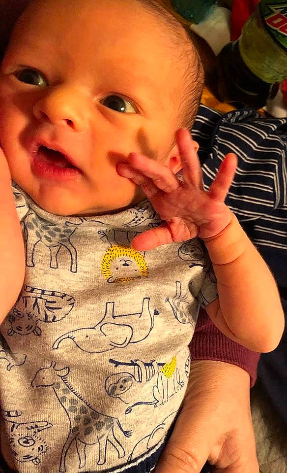 Weston is registered to the contest to win money with this photo: baby, cheek, child, chin, eye, face, finger, forehead, gesture, hand, head, lip, mouth, nail, nose, person, skin, smile, thumb, toddler