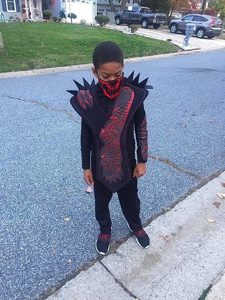 Jeremiah is registered to the contest to win money with this photo: asphalt, child, cool, footwear, jacket, jeans, outerwear, person, plant, road, shoe, style, vacation, walking