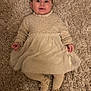 baby, child, infant, carpet, dress, beige, sweater, smile, cute, lying_down, footwear, room, texture, soft, young, portrait, indoor, person, toddler, cozy