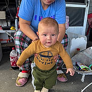Jayce joined the competition — help win amazing prizes! baby, adult, woman, porch, slippers, plaid_pajamas, sweatshirt, holding, hands, dr_pepper_bottle, concrete_floor, screen_door, door, toy_bag, candid, expression, cozy, indoor_outdoor, portrait, supporting_hands