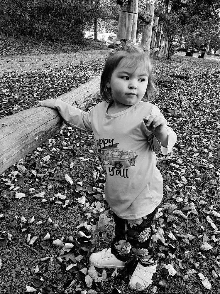 Charlotte Grace is registered to the contest to win money with this photo: arm, black, black_and_white, gesture, grass, hand, happy, human_body, mammal, nature, people_in_nature, person, photograph, plant, smile, standing, style, toddler, tree, vertebrate
