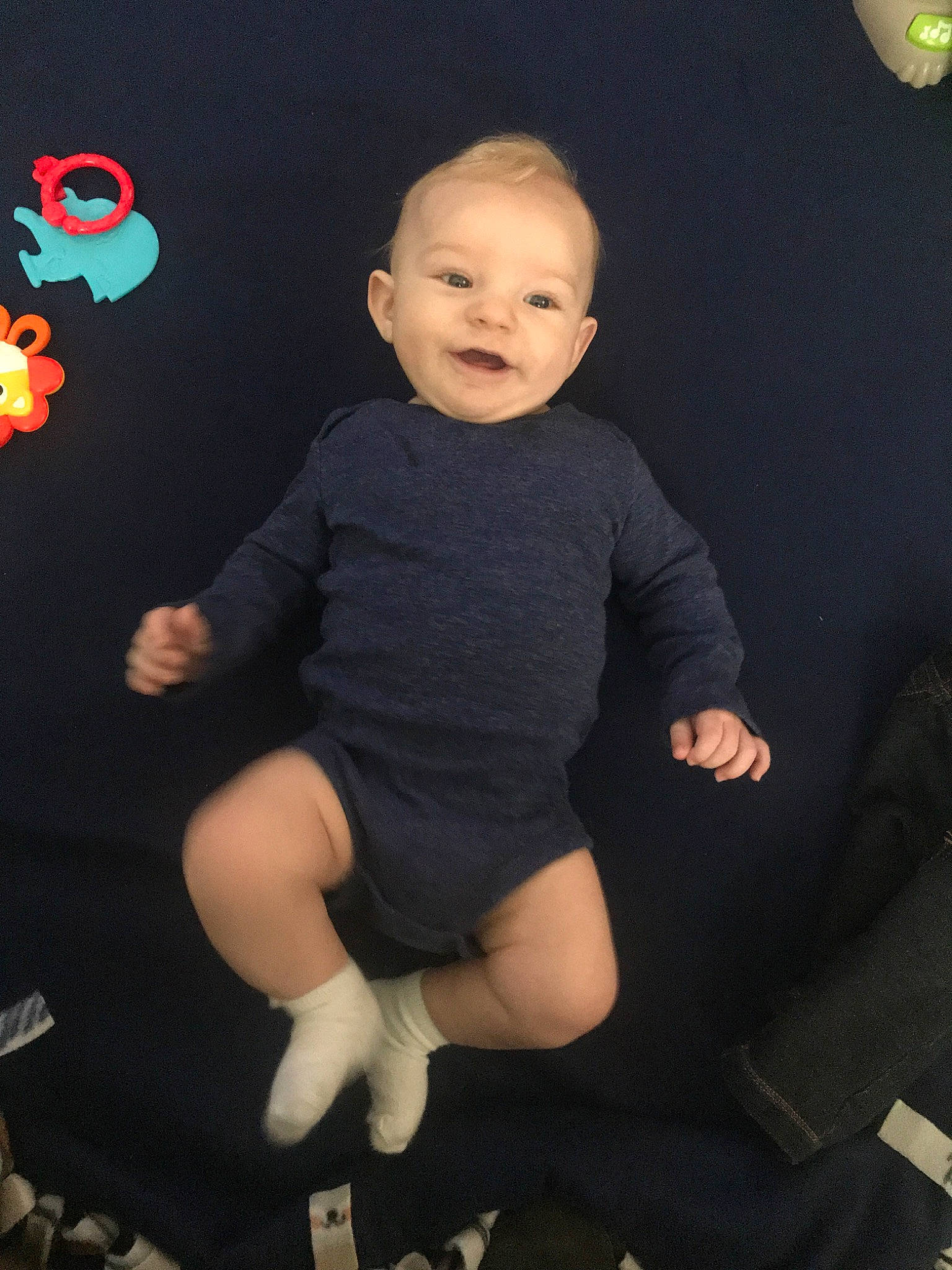 Nolan is registered to the contest to win money with this photo: arm, baby, cheek, child, face, fun, head, human_body, joint, leg, person, photography, play, sitting, skin, sleeve, smile, sportswear, t_shirt, toddler