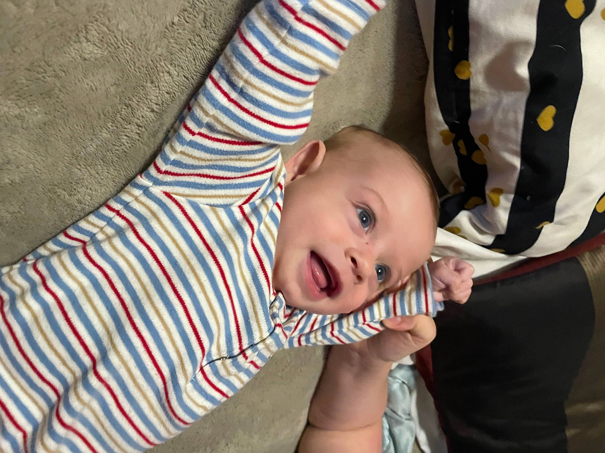 Randy James is registered to the contest to win money with this photo: baby, baby_products, baby_toddler_clothing, carmine, cheek, child, comfort, gesture, happy, linens, pattern, person, sitting, sleeve, smile, suit, textile, tie, toddler, tree
