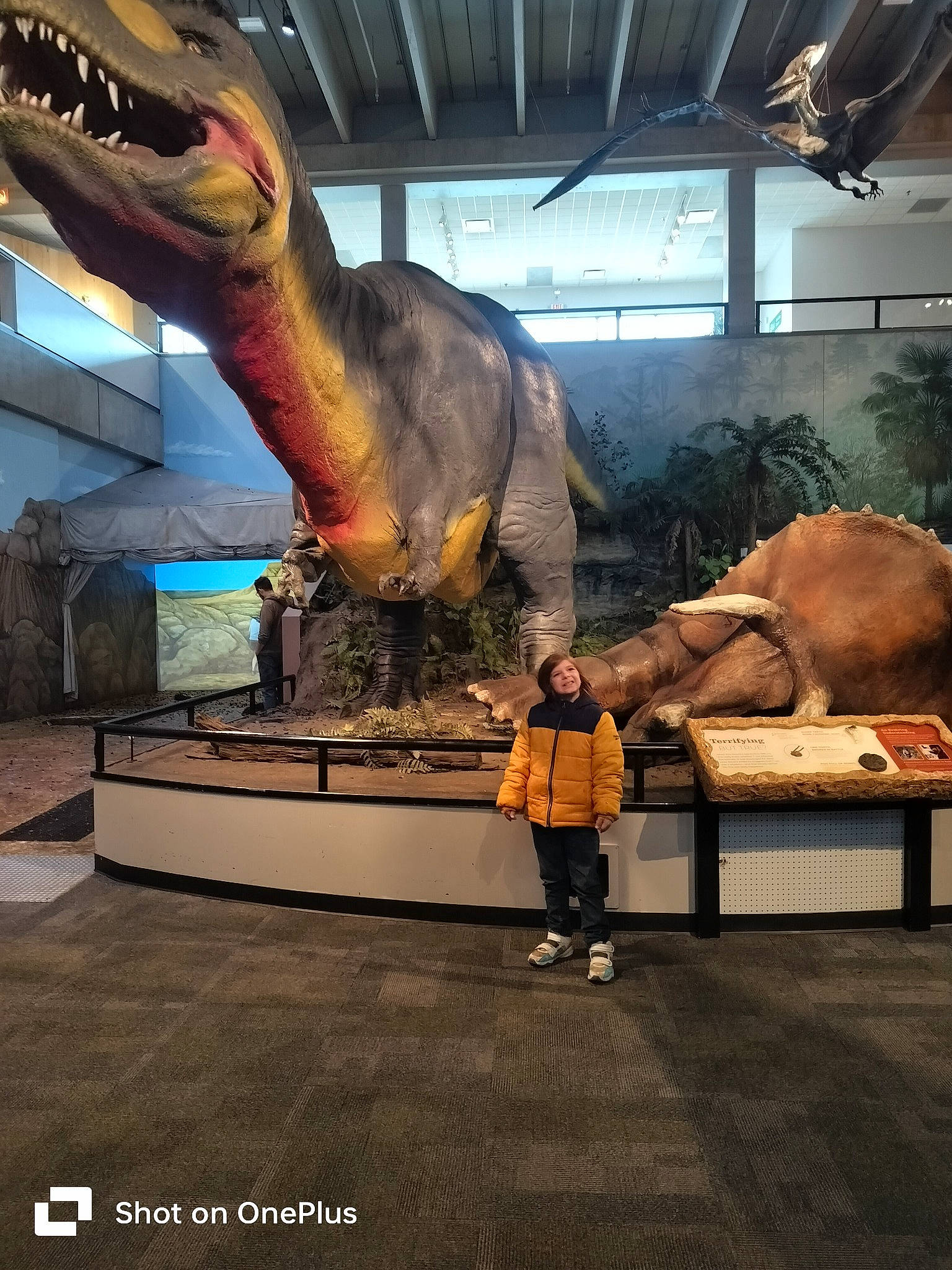 Zayden is registered to the contest to win money with this photo: art, dinosaur, elephants_and_mammoths, event, extinction, fossil, fun, jaw, joy, metal, person, sculpture, skeleton, statue, terrestrial_animal, tourist_attraction, tyrannosaurus, visual_arts, working_animal