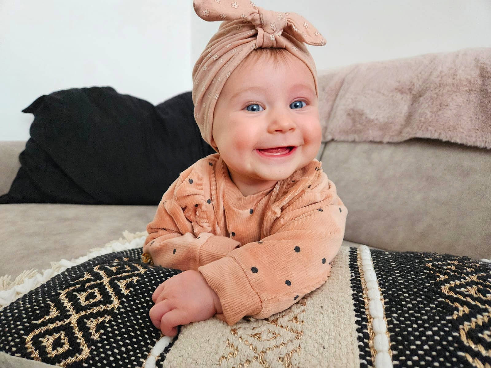 Alice a rejoint le concours — aidez-le/la à gagner de superbes lots ! arm, baby, baby_laughing, baby_toddler_clothing, child, comfort, couch, eye, face, happy, joy, linens, outerwear, pattern, person, room, sitting, skin, sleeve, smile