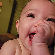 Paisley joined the competition — help win amazing prizes! baby, smiling, happy, close_up, hand, face, infant, cute, skin, eyes, mouth, portrait, child, human, expression, cheerful, indoors, natural_light, young, sucking_thumb