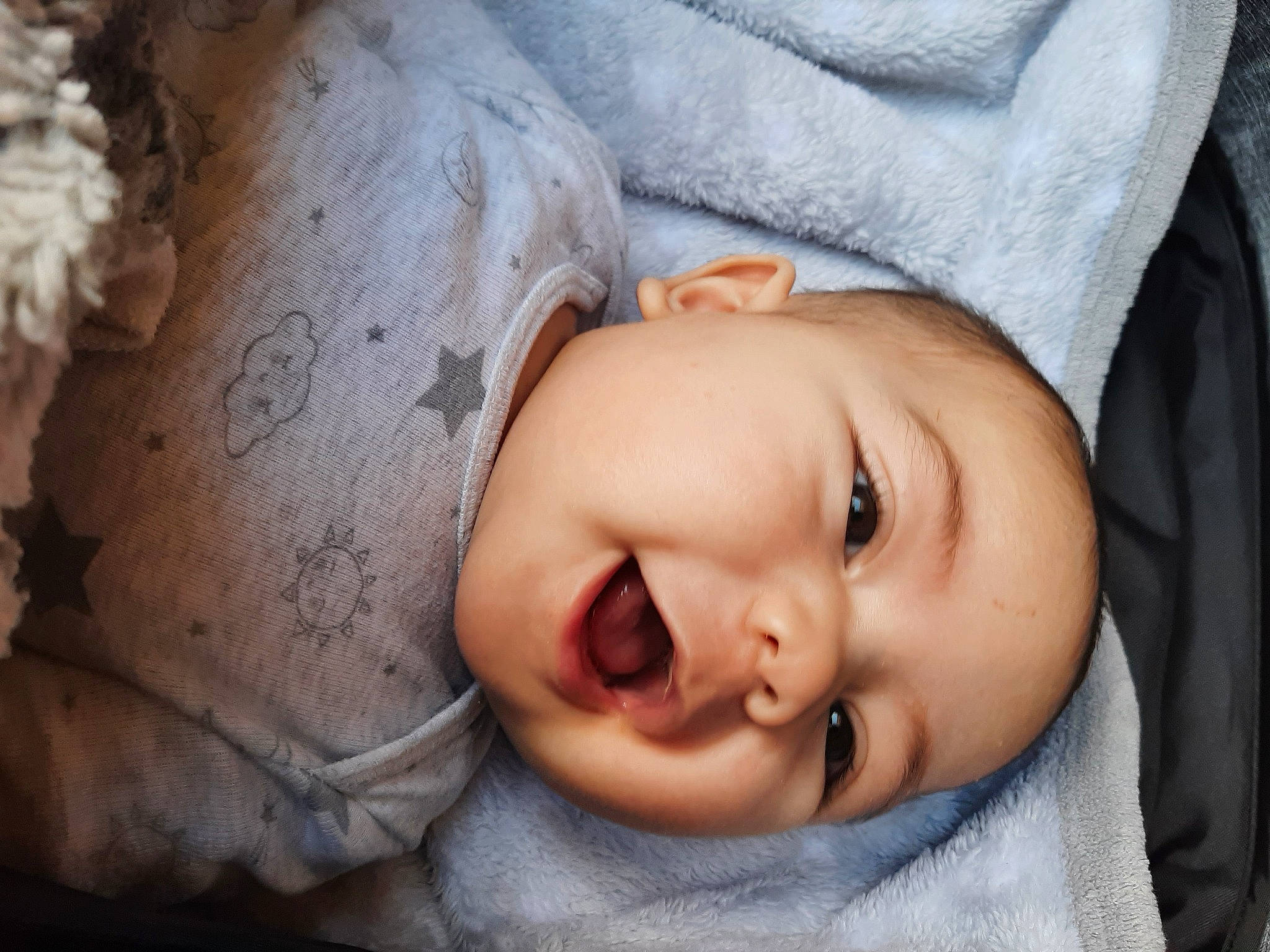 Ulysses is registered to the contest to win money with this photo: baby, baby_toddler_clothing, cheek, comfort, eye, eyebrow, eyelash, flash_photography, happy, headgear, headwear, human_body, iris, lip, mouth, nose, person, skin, sleeve, smile