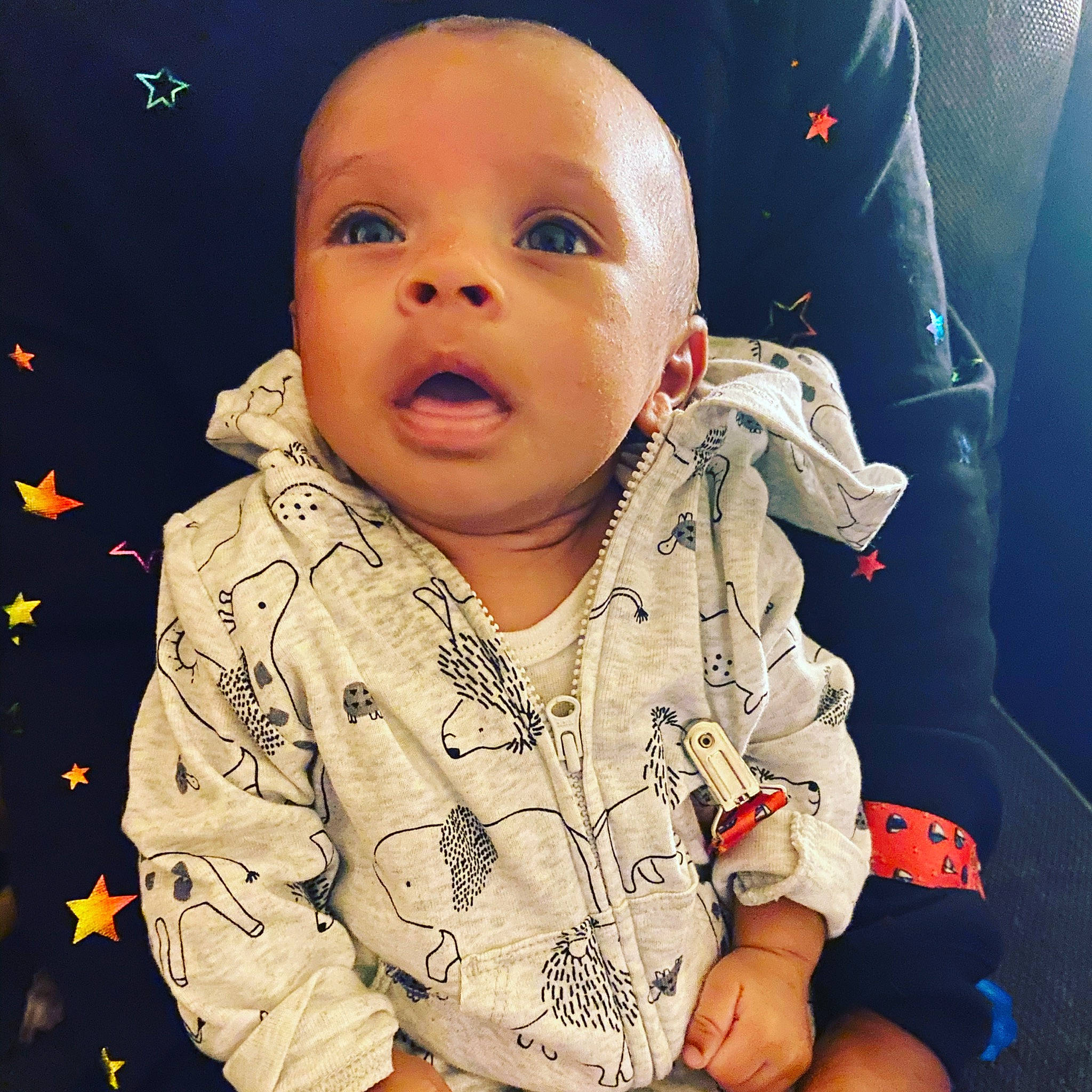 Elias is registered to the contest to win money with this photo: arm, baby, cheek, child, chin, cool, eye, face, finger, forehead, fun, head, human, lip, nose, outerwear, person, skin, sleeve, smile