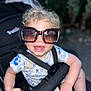 Ilan participe au concours pour gagner de l'argent avec cette photo : accessory, baby, casual, child, curly_hair, cute, daylight, fashion, happy, infant, outdoor, person, playful, seat, seatbelt, smile, stroller, summer, sunglasses, toddler