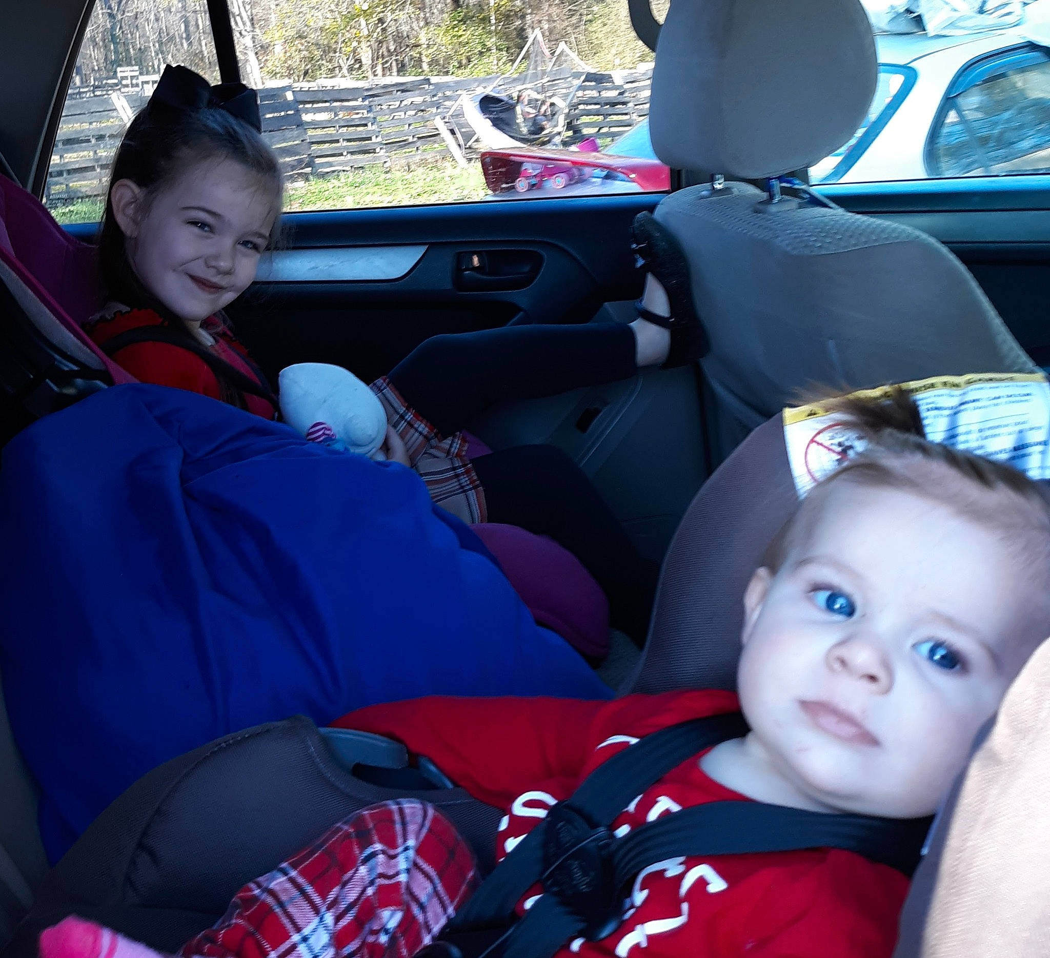 Amelia is registered to the contest to win money with this photo: auto_part, automotive_design, automotive_exterior, car, car_seat, car_seat_cover, child, comfort, family_car, head_restraint, joy, motor_vehicle, person, plaid, smile, steering_part, steering_wheel, tartan, toddler, vehicle