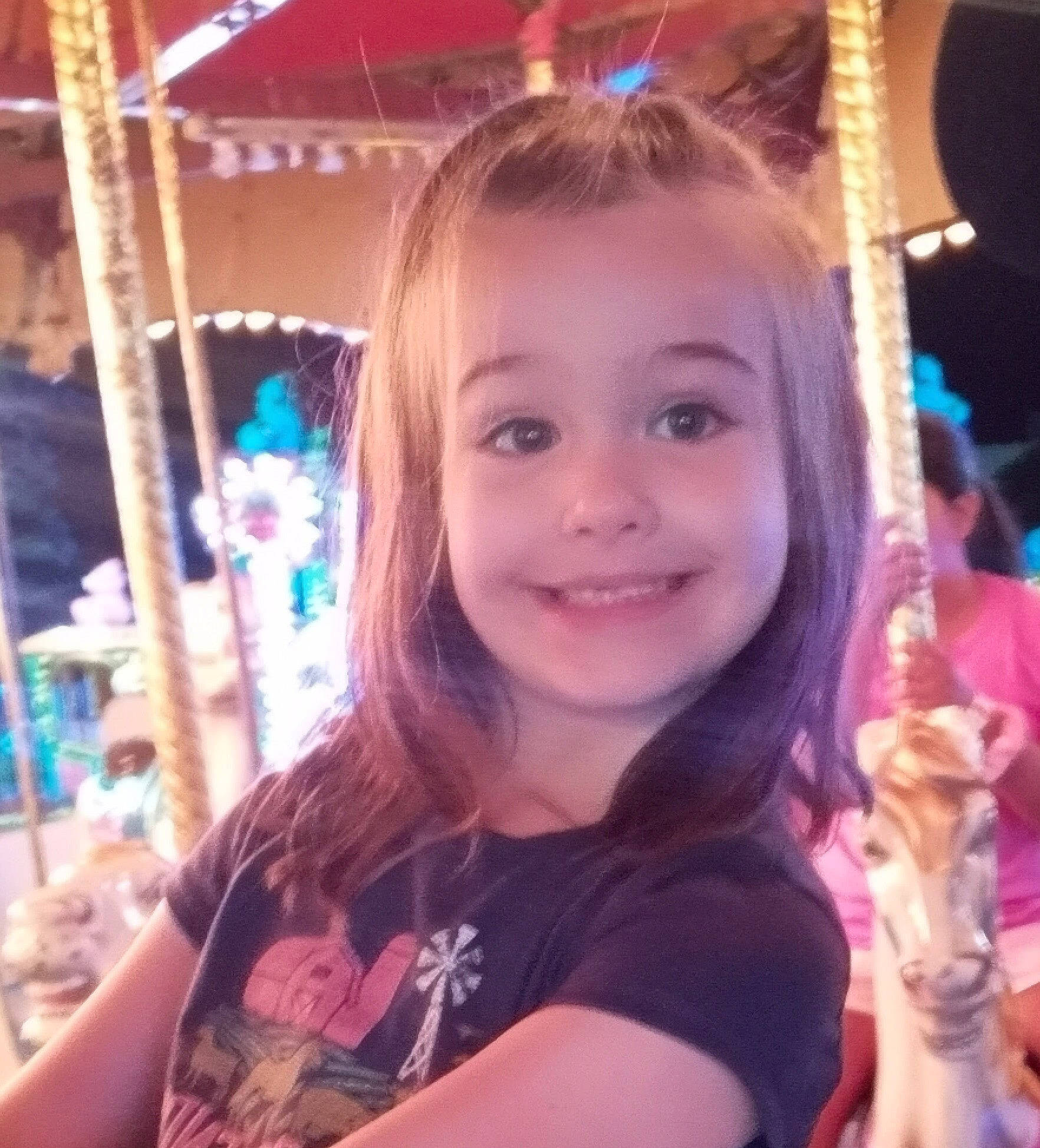 Adrian is registered to the contest to win money with this photo: amusement_ride, bangs, beauty, blond, brown_hair, carousel, child, chin, cool, ear, event, fun, hairstyle, happy, iris, joy, leisure, long_hair, person, recreation