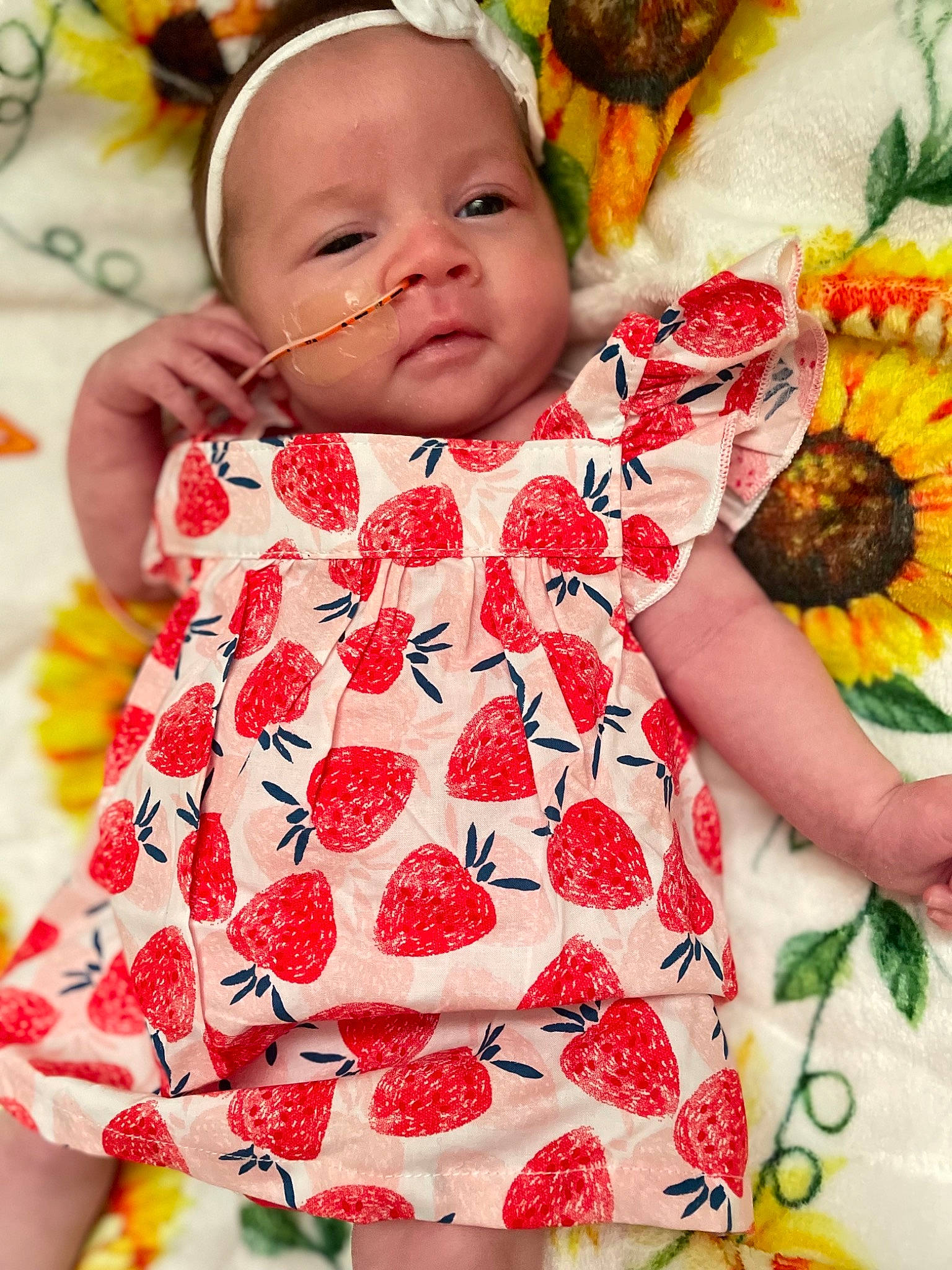 Araya is registered to the contest to win money with this photo: baby, baby_toddler_clothing, child, dress, face, facial_expression, green, happy, head, orange, person, photograph, pink, product, red, skin, sleeve, textile, toddler, white