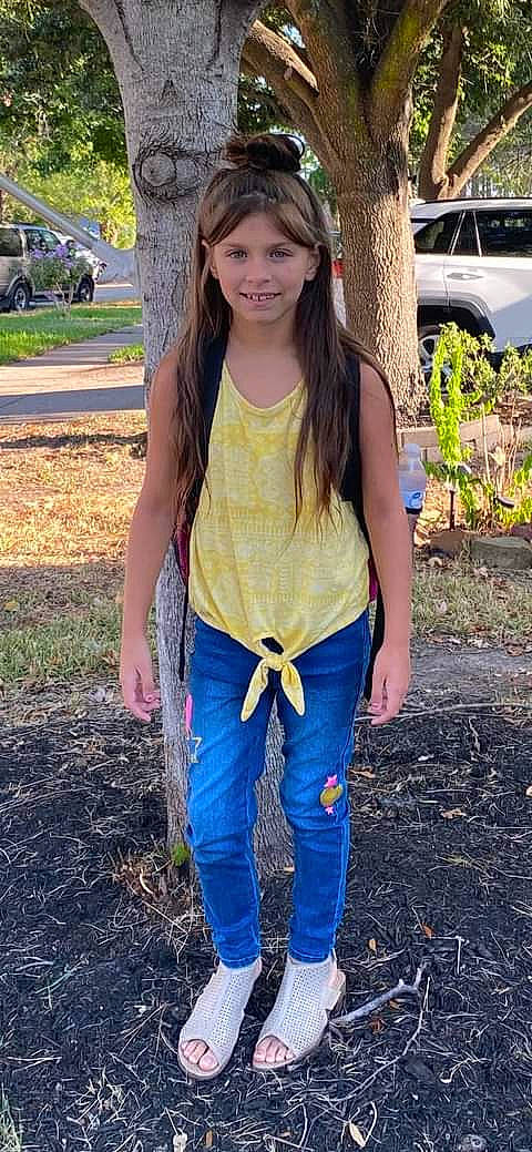 Annabelle is registered to the contest to win money with this photo: denim, electric_blue, eye, fawn, fun, grass, happy, head, joy, leg, long_hair, outerwear, people_in_nature, person, plant, smile, thigh, tire, tree, trunk