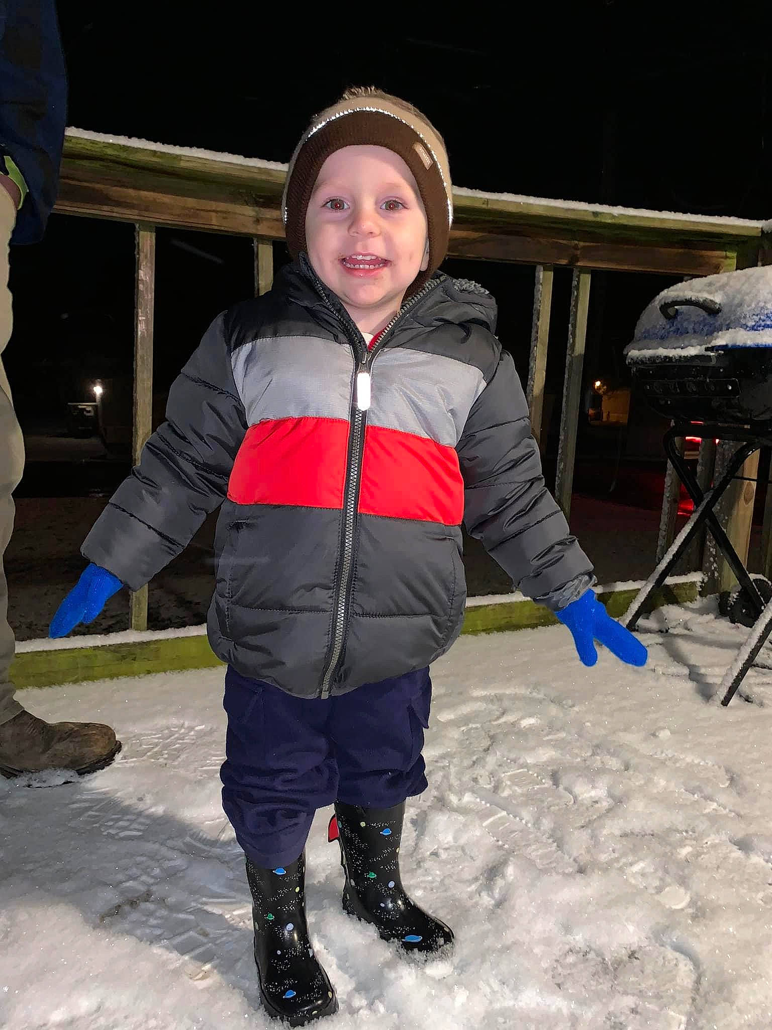 Brandon is registered to the contest to win money with this photo: chair, child, electric_blue, freezing, fun, headwear, hood, hoodie, ice_cap, jacket, leisure, person, personal_protective_equipment, recreation, shoe, smile, sneakers, snow, snow_boot, toddler