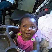 Kamiah Frelix joined the competition — help win amazing prizes! toddler, child, high_chair, smiling, pink_clothing, indoor, furniture, bed, blanket, happy, person, baby, seat, home, portrait, cute, young_child, infant, bright_eyes, hands