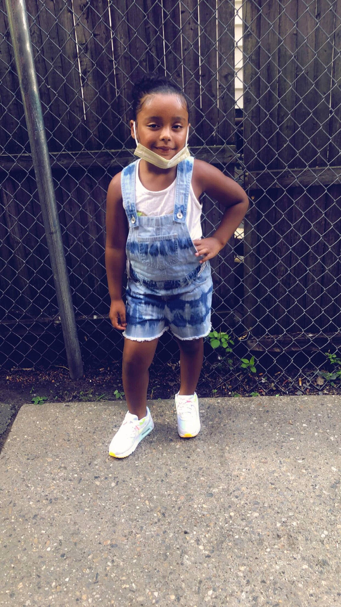 Bella is registered to the contest to win money with this photo: baby_toddler_clothing, child, electric_blue, face, fence, fun, grass, happy, human_leg, joy, leisure, mesh, pattern, person, shorts, sleeve, smile, street_fashion, t_shirt, thigh