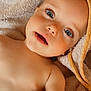 Lucïe participe au concours pour gagner de l'argent avec cette photo : baby, blanket, blue_eyes, child, closeup, curious, cute, expression, eyelashes, face, head, indoors, infant, person, portrait, skin, soft, towel, warm, young