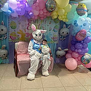Mateo joined the competition — help win amazing prizes! baby, child, easter_bunny, costume, balloons, pastel_colors, easter, holiday, celebration, indoor, decoration, festive, person, floor, chair, banner, cute, smiling, event, holiday_theme