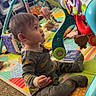 Mateo is registered to the contest to win money with this photo: toddler, child, baby, play_mat, toy_gym, colorful, indoor, carpet, onesie, curious, baby_toys, animal_toy, interactive_toy, sitting, floor_play, young_child, home, cute, soft_lighting, entertained